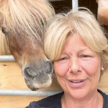 The founder of Nature, Horses & Holistics cheek to cheek with a Shetland pony.
